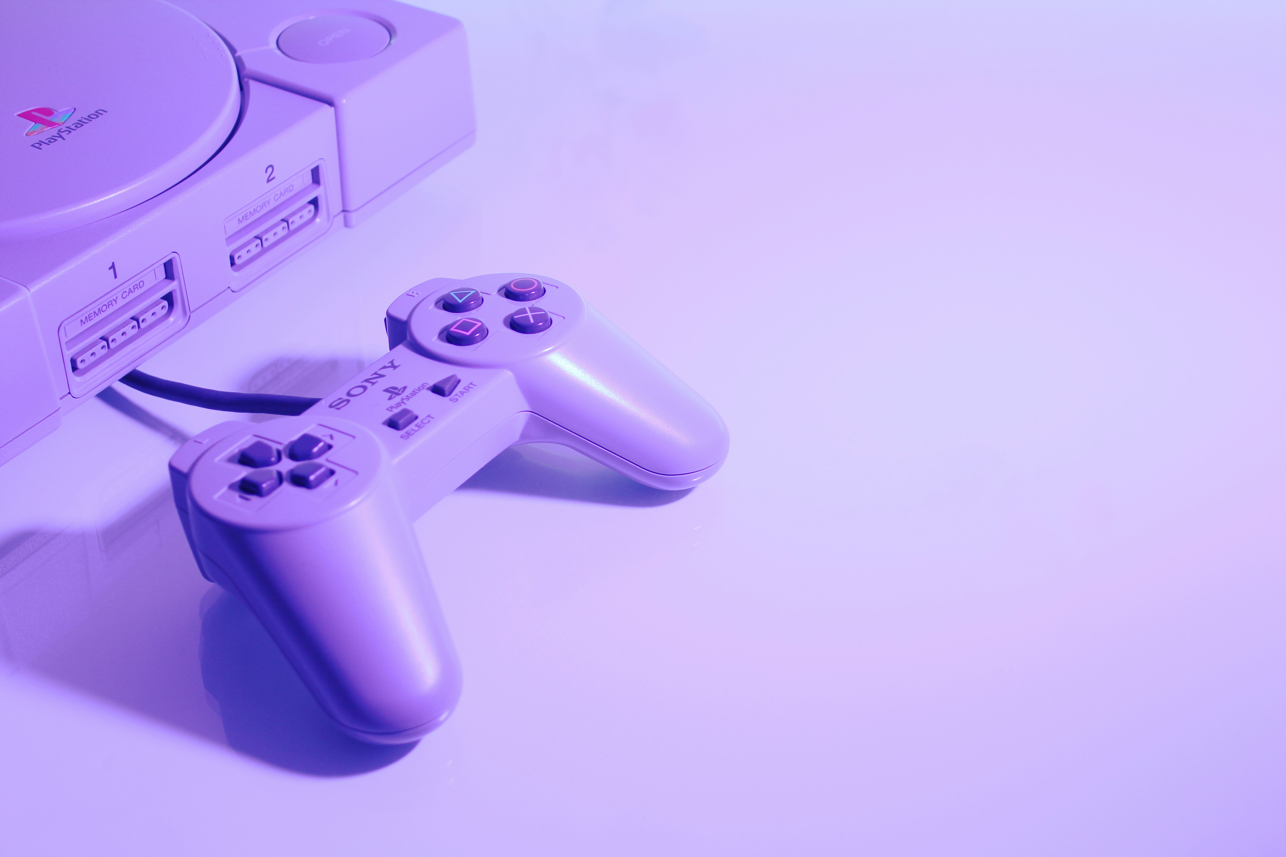 An image of
        a wired Playstation One controller and console.